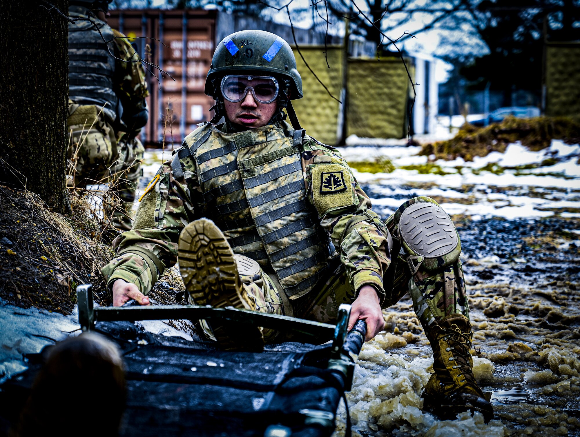 A U.S. Army Soldier, Army Support Activity Dix, opens a lightweight foldable field stretcher at the Medical Simulation Training Center (MSTC) on Feb. 3, 2022, at Joint Base McGuire-Dix-Lakehurst, N.J. The MSTC provides state of the art training in treating all areas of trauma and basic medical scenarios. Under the principles of Tactical Casualty Combat Care (TC3), students gain knowledge and skills to treat severe bleeding, manage a tension pneumothorax, and establish a secure airway. The MSTC offers TC3 training through classroom instruction, basic hands-on training, and the use of realistic trauma and medical scenarios. The functional skills developed are supported and reinforced by a final simulated battlefield exercise. This immersive environment helps to familiarize the student with potential environments found in deployed environments.