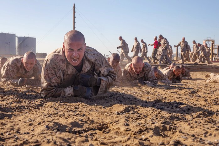 U.S. Marine Corps recruits with Delta Company, 1st Recruit Training Battalion, low crawl while participating in the Combat Conditioning Course at Marine Corps Recruit Depot San Diego, Feb. 02, 2022.