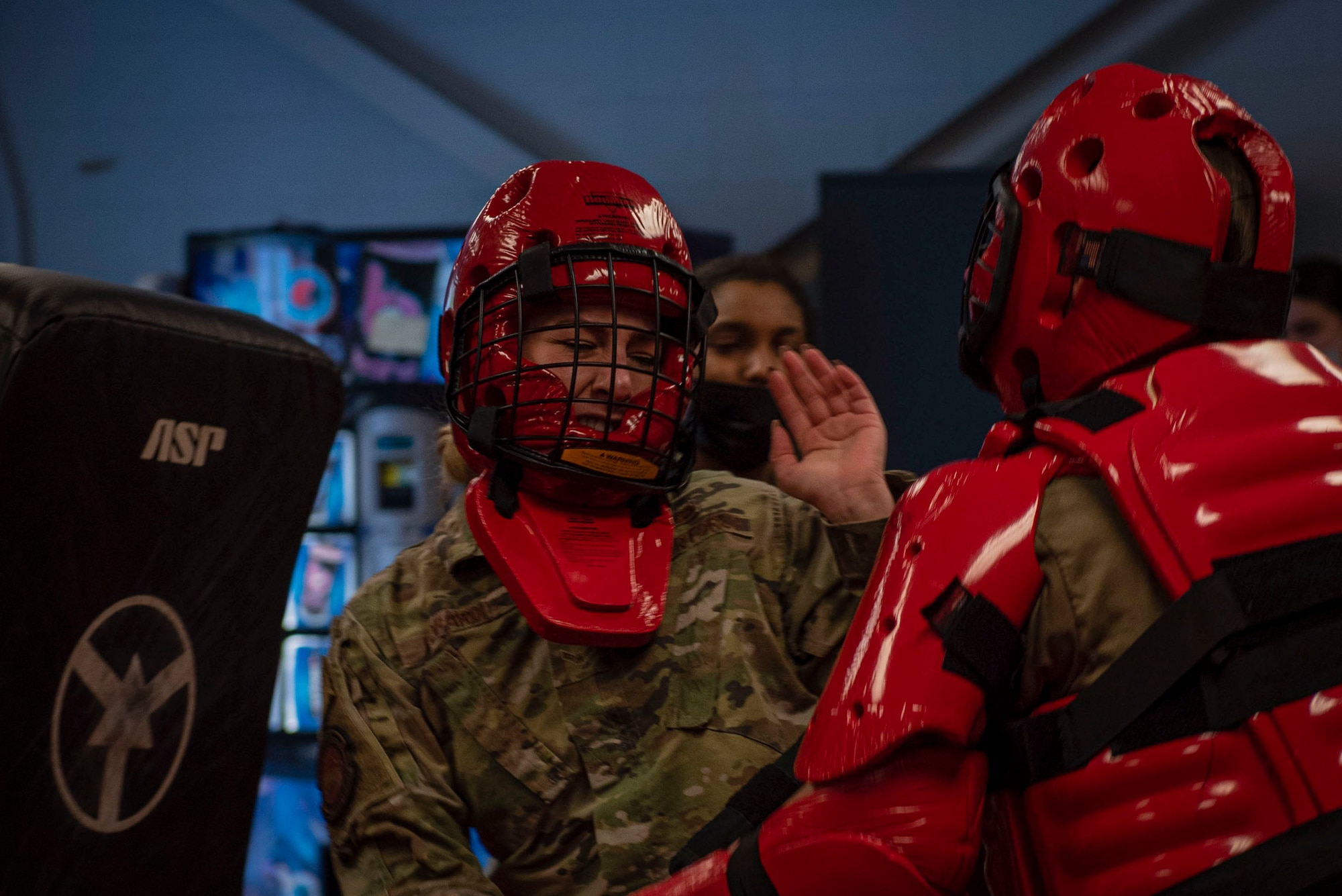 Airman 1st Class Megan Leopardi, left, 4th Security Forces Squadron patrolman, attacks a security forces instructor as part of a training course at Seymour Johnson Air Force Base, North Carolina, Jan. 26, 2022. Red man is a defender course for Airmen to learn how to perform lethal and non-lethal strikes on adversaries. (U.S. Air Force photo by Airman 1st Class Sabrina Fuller)