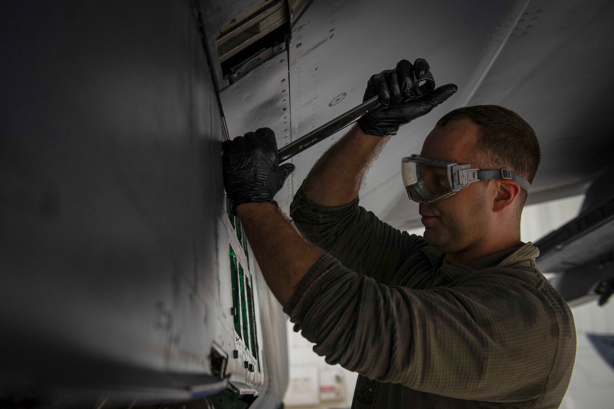Staff Sgt. Matthew Carpenter, 334th Fighter Generation Squadron dedicated crew chief, fixes a utility accessor manifold at Seymour Johnson Air Force Base, North Carolina, Jan. 18, 2022. The utility assessor manifold distributes hydrofoil to utility systems on F-15E Strike Eagle aircraft. (U.S. Air Force photo by Airman 1st Class Sabrina Fuller)