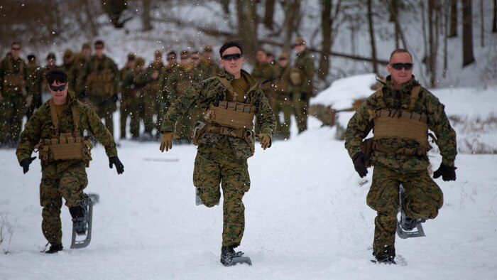 U.S. Marines with Bravo Company, 1st Battalion, 2d Marine Regiment, 2d Marine Division, conduct a relay race with snowshoes to build confidence in their gear near Camp Dawson, West Virginia, Feb. 2, 2022. This exercise is the third phase of a specialized training evolution to determine the efficacy of 2d MARDIV’s experimental battalion. (U.S. Marine Corps photo by Lance Cpl. Ryan Ramsammy)