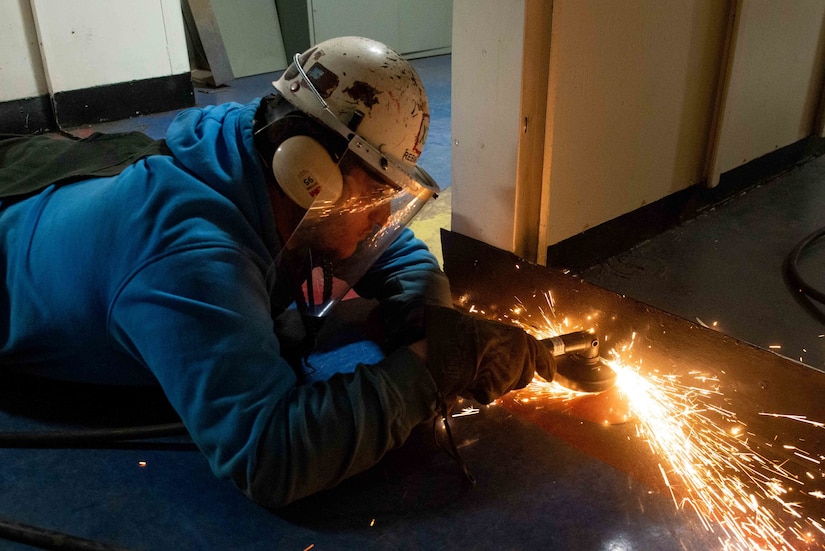 A welder cuts metal.