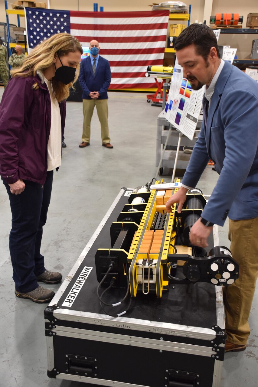 The Honorable Meredith Berger, Assistant Secretary of the Navy for Energy, Installations and Environment and performing the duties of the Under Secretary of the Navy is briefed by Raymond Pluhar, Naval Oceanographic Office oceanographer, on Fleet Survey Team capabilities in the oceanographic high bay of FST during her first visit to Naval Oceanography and Meteorology Command (NMOC) at NASA Stennis Space Center, Mississippi, Feb. 3, 2022. Naval Meteorology and Oceanography Command directs and oversees more than 2,500 globally-distributed military and civilian personnel who collect, process and exploit environmental information to assist Fleet and Joint Commanders in all warfare areas to make better decisions faster than the adversary.
