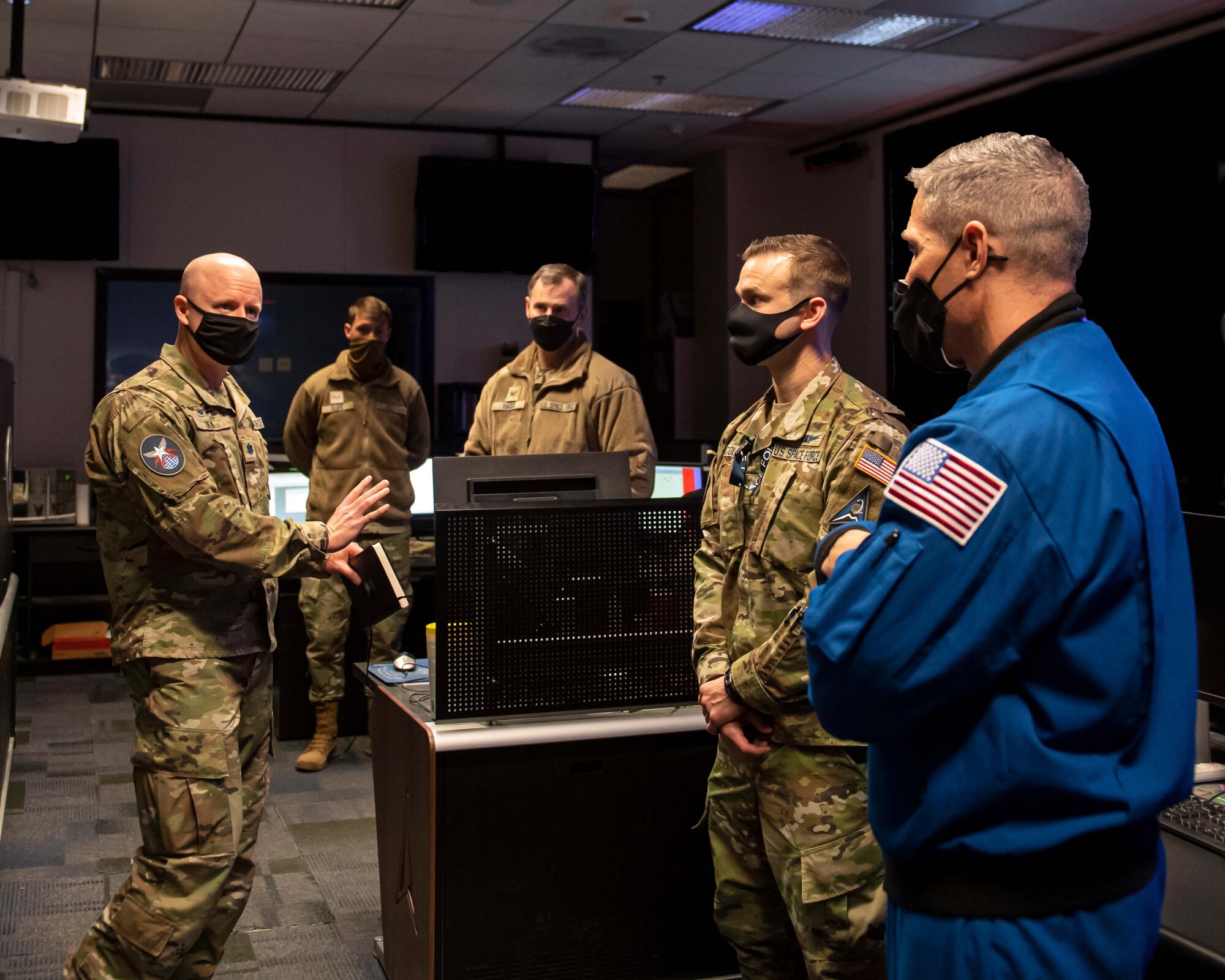 U.S. Space Force Col. Mike S. Hopkins, NASA astronaut, tours the operations floor of 4th Space Operations Squadron during his daylong visit to Schriever Space Force Base, Colorado, Jan. 27, 2022. Space Delta 8 – Satellite Communications and Navigational Warfare, 4th SOPS provides warfighters global, secure, survivable, strategic and tactical communication during peacetime and throughout the full spectrum of conflict. (U.S. Space Force photo illustration by Tiana Williams)