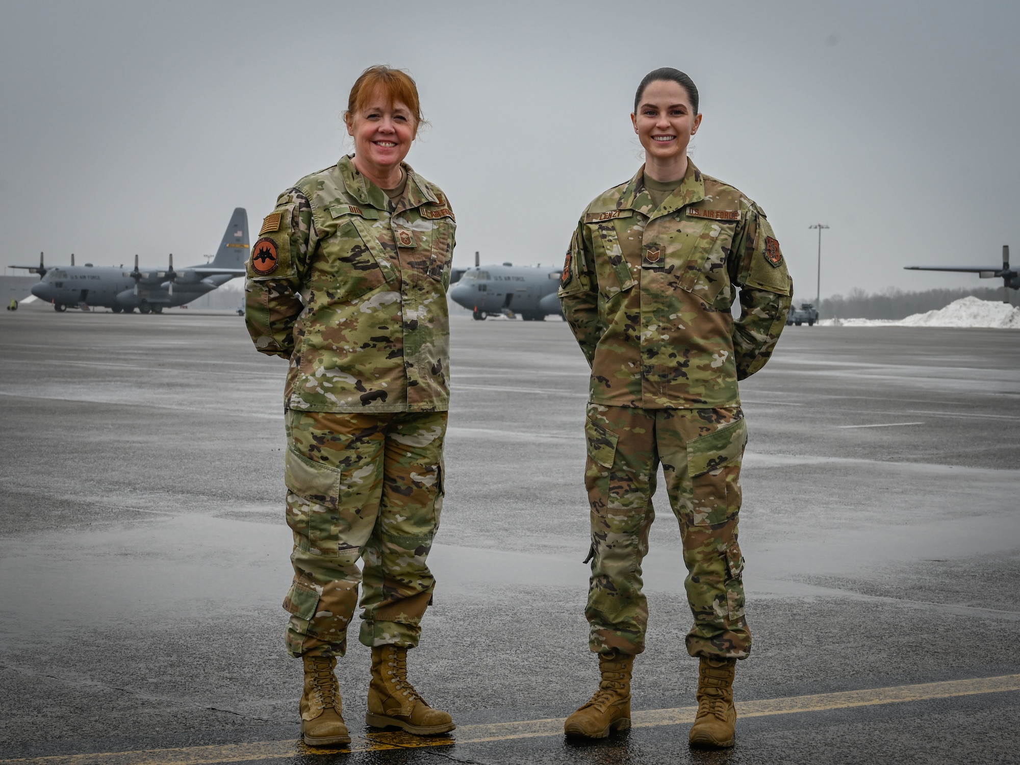 U.S. Air Force Senior Master Sgt. Winnie Dion, left, 103rd Operations Support Squadron airfield manager, and Tech. Sgt. Jennifer Lenzi, 103rd Operations Support Squadron noncommissioned officer in charge of airfield management operations, on the flight line at Bradley Air National Guard Base in East Granby, Conn., Feb. 3, 2022. The airfield management team was named Ronald B. McCarthy Airfield Management Facility of the Year as part of the Air National Guard’s 2021 Airfield Management Operations Awards, and Dion and Lenzi were named Airfield Management Senior Noncommissioned Officer of the Year and Noncommissioned Officer of the Year, respectively. (U.S. Air National Guard photo by 2nd Lt. Steven Tucker)