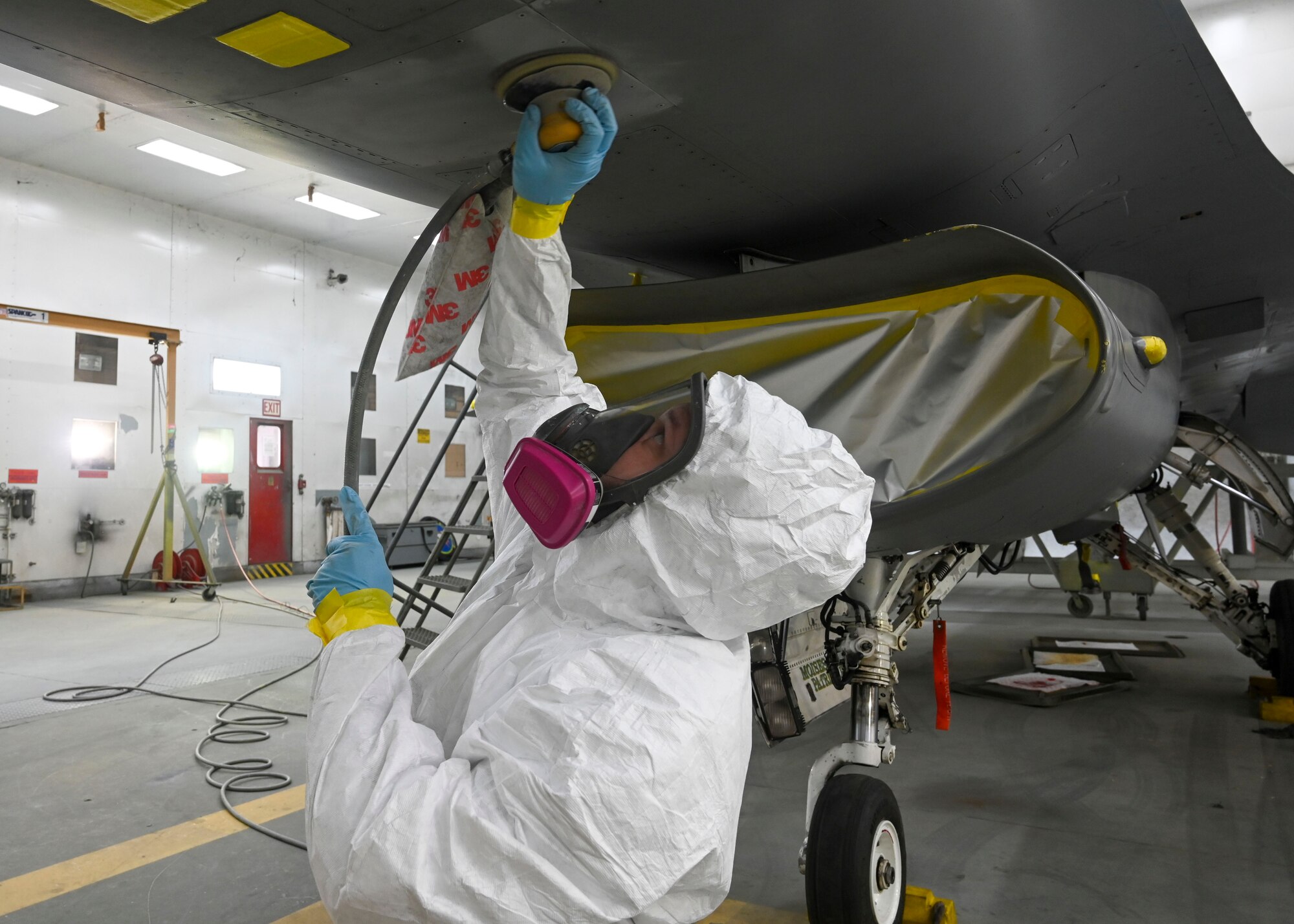 U.S. Air Force Staff Sgt. Robert Klein, 56th Equipment Maintenance Squadron low observable aircraft structural maintenance craftsman, preps an F-16 Fighting Falcon for repainting Jan. 9, 2022, at Luke Air Force Base, Arizona.