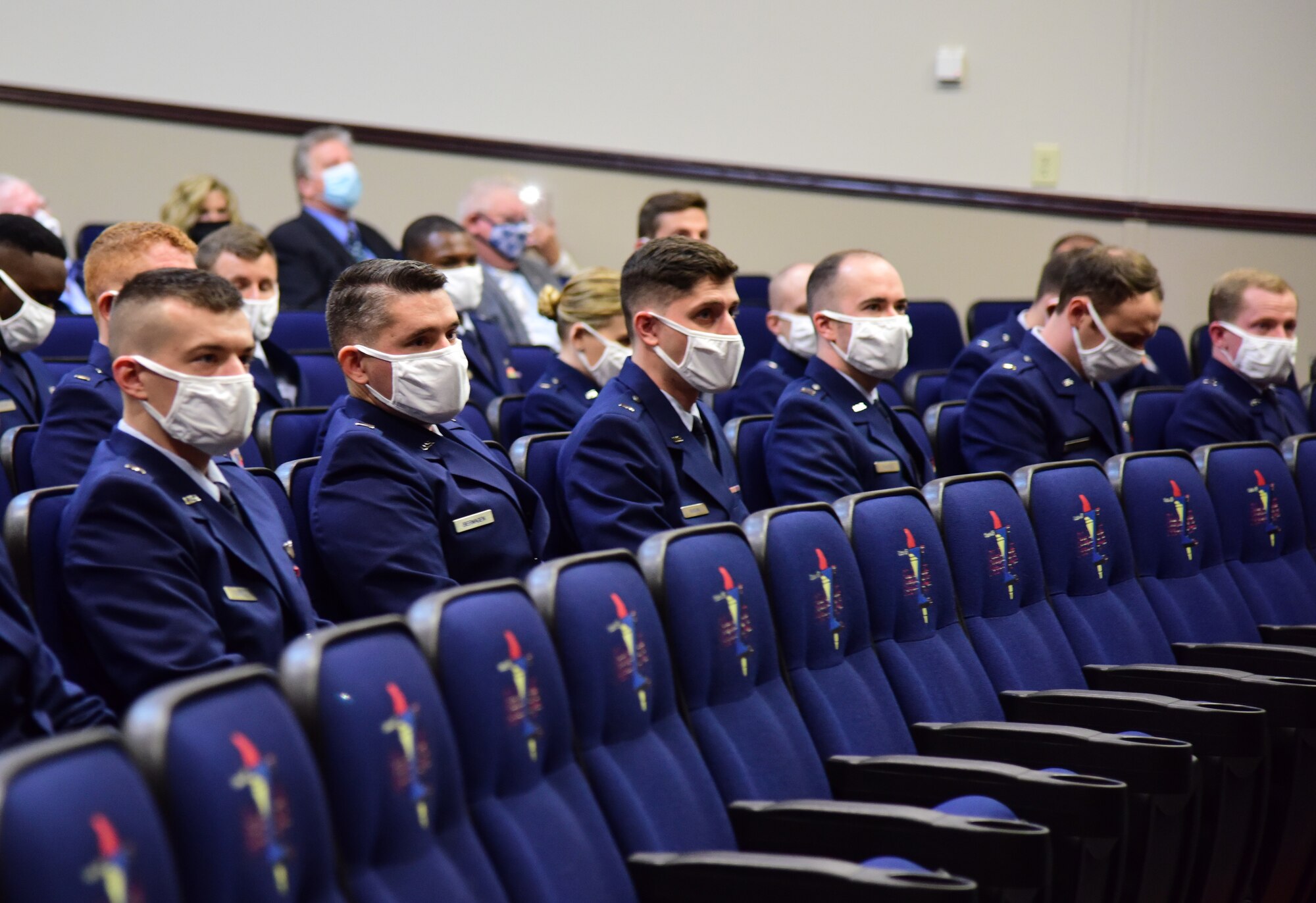 Graduates from Specialized Undergraduate Pilot Training class 22-05 sit at the graduation ceremony in the Kaye Auditorium Feb 4, 2022, on Columbus Air Force Base, Miss. Paralleling their flying training, students also need to complete around 400 hours of flight-related classroom instruction. (U.S. Air Force photo by Melissa Duncan-Doublin)