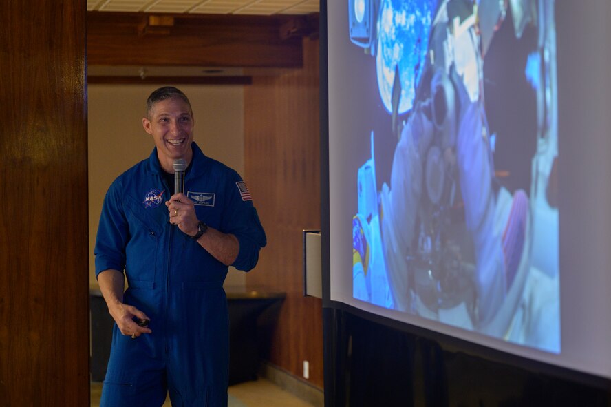 U.S. Space Force Col. Mike Hopkins, NASA astronaut, reminisces about a space selfie he captured while performing a spacewalk outside of the International Space Station during a presentation at Peterson Space Force Base, Colorado, Jan. 25, 2022. Hopkins, who most recently commanded Crew-1 SpaceX Crew Dragon and served as flight engineer for Expedition 64 to the ISS, shared stories from his two missions to the ISS. (U.S. Space Force photo by Paul Honnick)