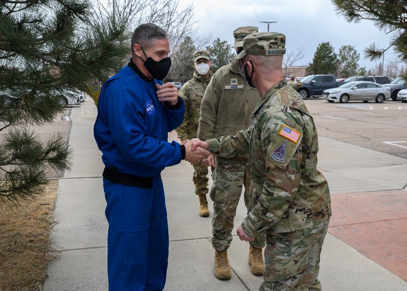 U.S. Space Force Col. Shay Warakomski, Peterson-Schriever Garrison commander, welcomes U.S. Space Force Col. Mike Hopkins, NASA astronaut, to Peterson Space Force Base, Colorado, Jan. 25, 2022. Hopkins, the first astronaut to transfer into the Space Force, visited Airmen and Guardians from P-S GAR, Space Operations Command and Space Training and Readiness Command from Peterson SFB and Schriever SFB. (U.S. Space Force photo by Paul Honnick)