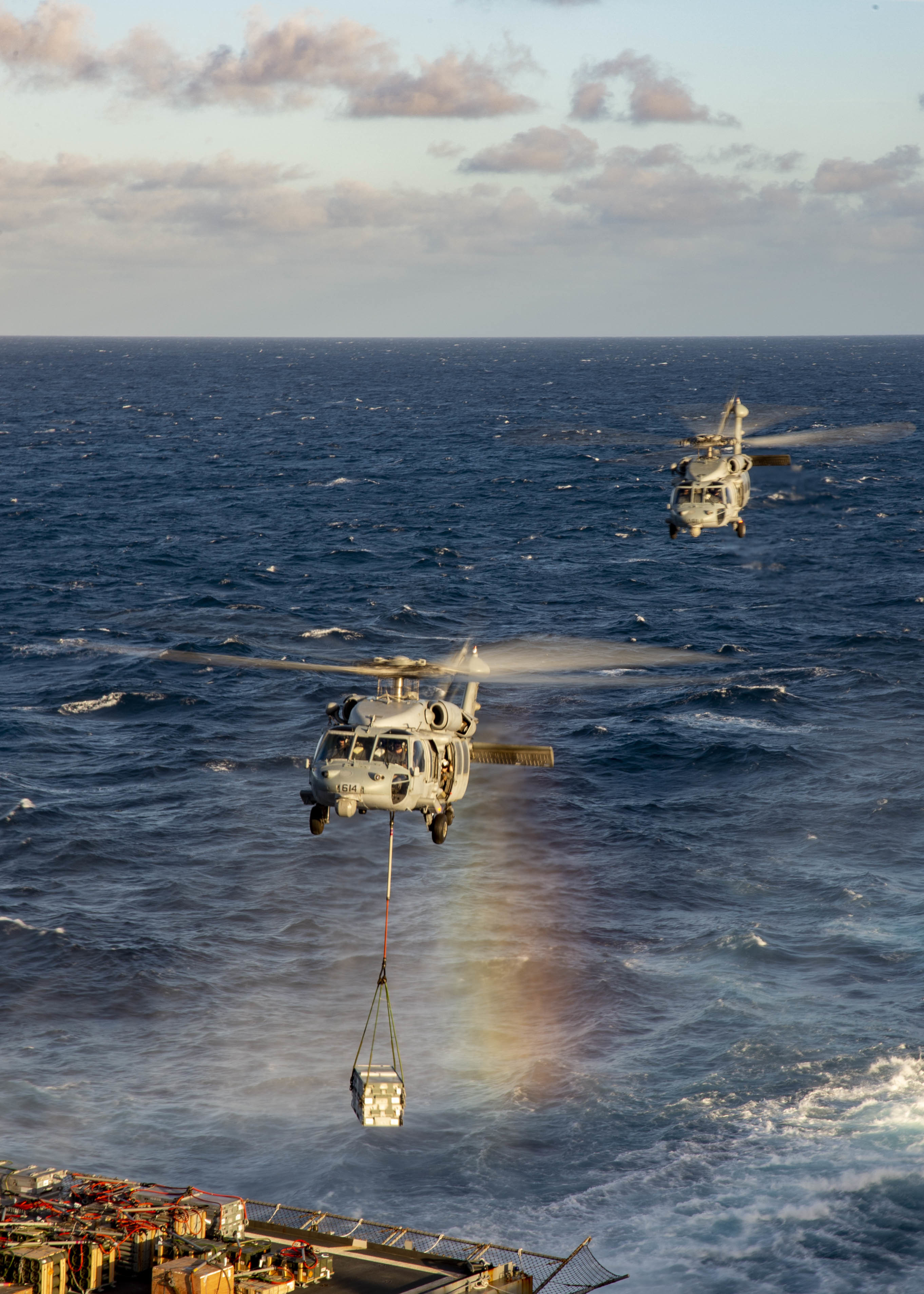 Two MH-60S Sea Hawk helicopters, attached to Helicopter Sea Combat Squadron (HSC) 5, retrieves ammunition from the dry cargo and ammunition ship USNS Medgar Evers (T-AKE 13) during a vertical replenishment with the aircraft carrier USS George H.W. Bush (CVN 77).