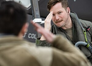 a photo of an F-35 pilot saluting a crew chief