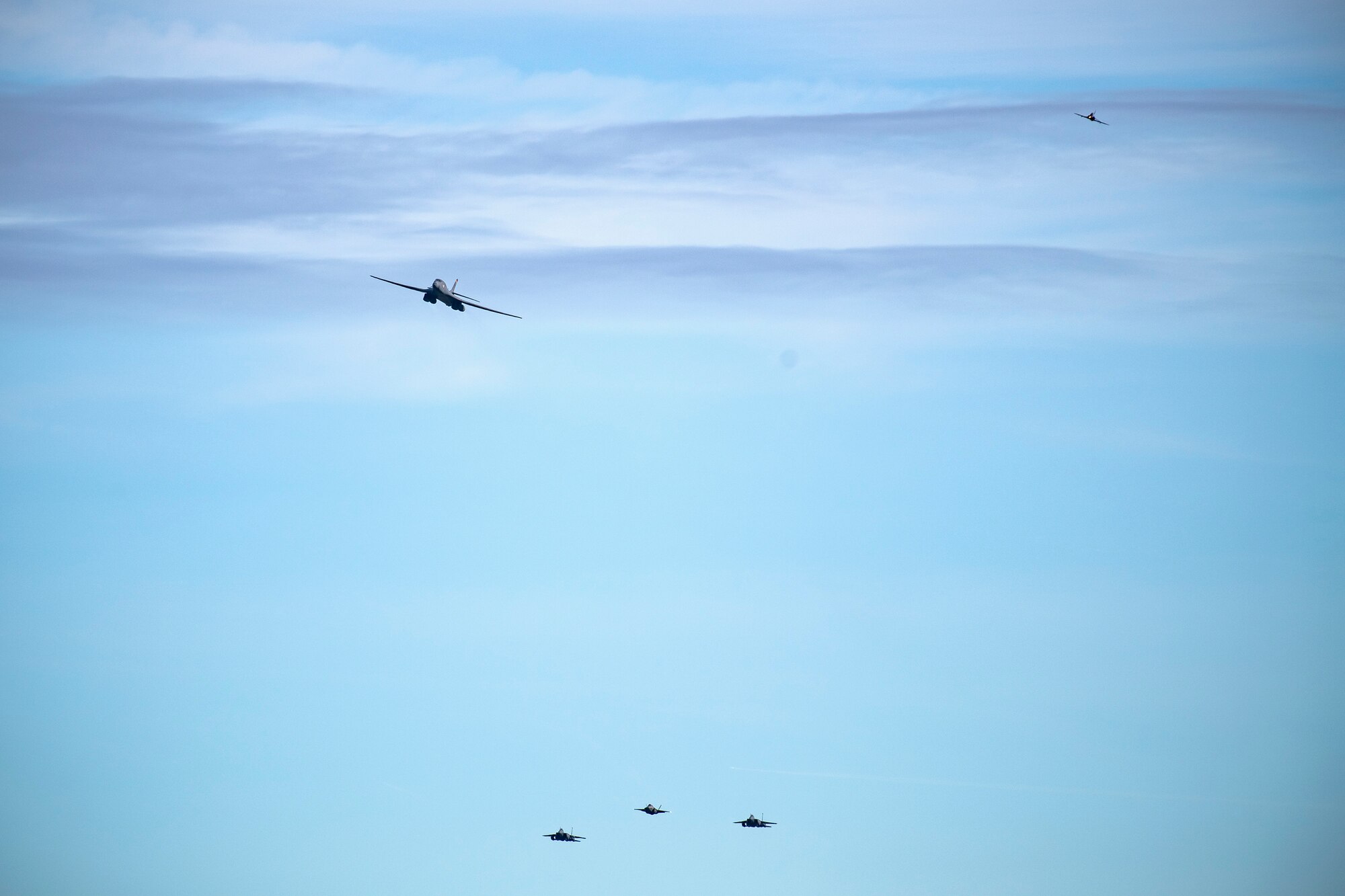 Aircraft from the U.S. Air Force and the Royal Air Force fly overhead at Duxford Airfield, England, Feb. 1, 2021. The flyover was in commemoration of the 80th anniversary of the Eighth Air Force. Events like these celebrate the continued USAF-RAF partnership and observe dissimilar U.S. and RAF aircraft integrating on approach to Duxford Airfield. (U.S. Air Force photo by Senior Airman Eugene Oliver)