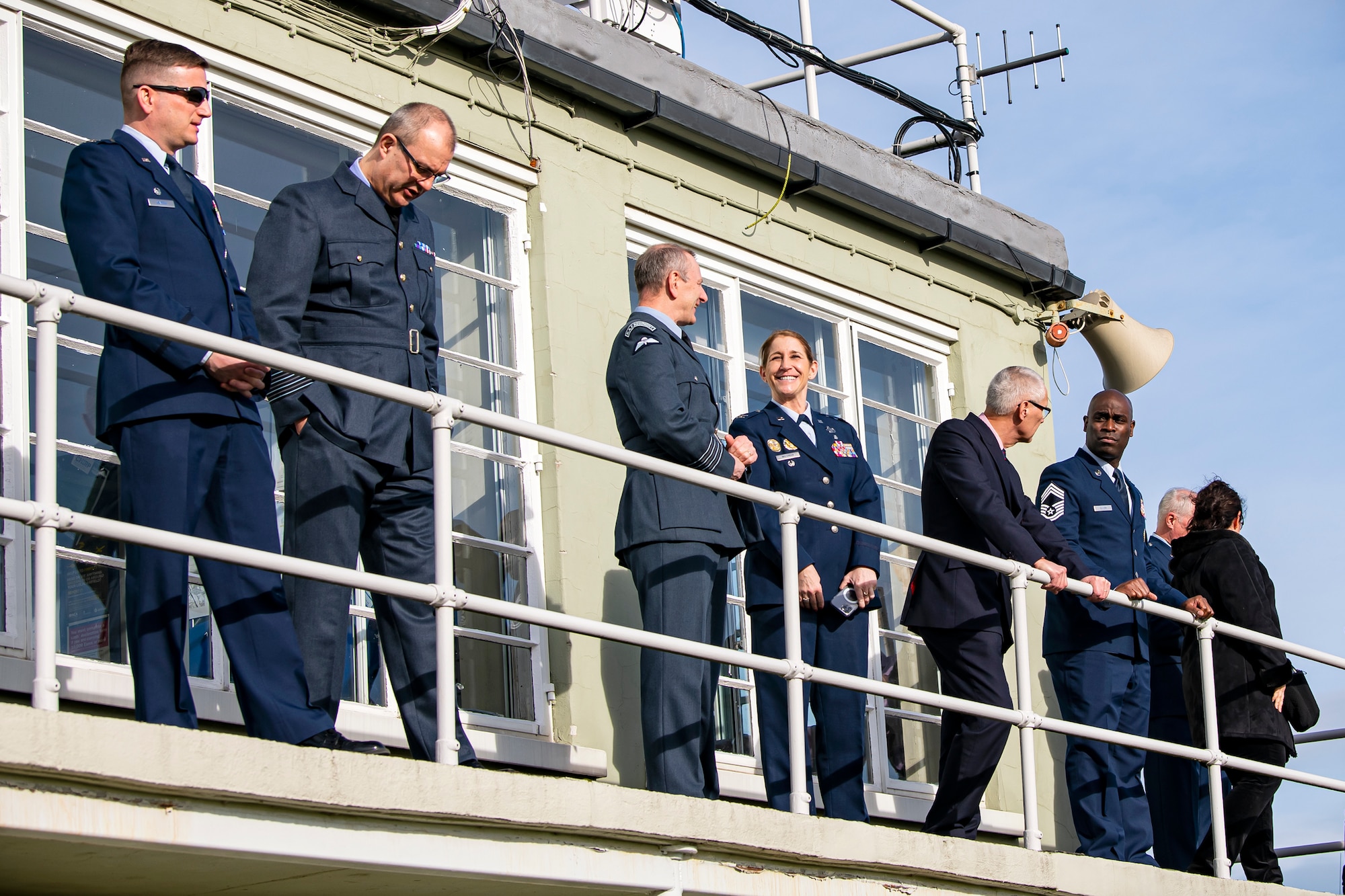 Leadership from the 501st Combat Support Wing and 423rd Air Base Group observe a flyover at Duxford Airfield, England, Feb. 1, 2021. The flyover was in commemoration of the 80th anniversary of the Eighth Air Force. Events like these celebrate the continued U.S. Air Force-Royal Air Force partnership and observe dissimilar U.S. and RAF aircraft integrating on approach to Duxford Airfield. (U.S. Air Force photo by Senior Airman Eugene Oliver)