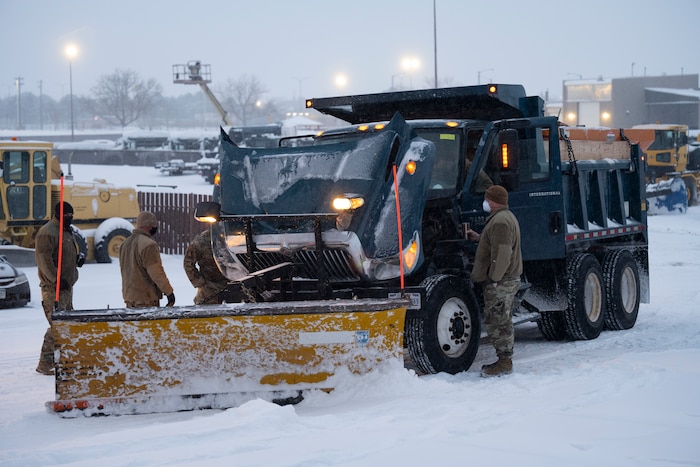 People fix snowplow