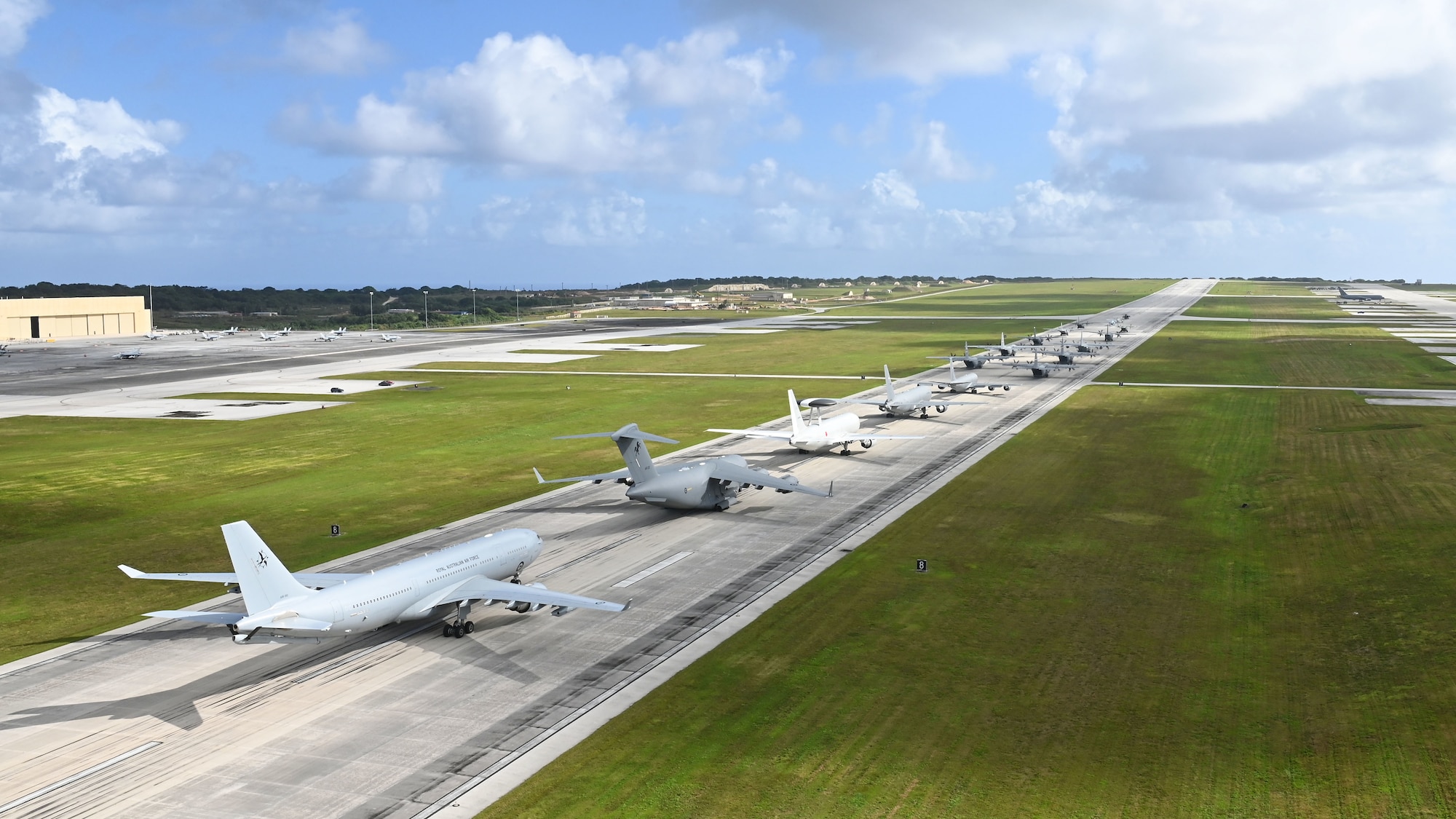 U.S. Air Force, Royal Australian Air Force and Japan Air Self-Defense Force aircraft participate in a close formation taxi, known as an Elephant Walk, during Cope North 2022 at Andersen Air Force Base, Guam, Feb. 5, 2022.