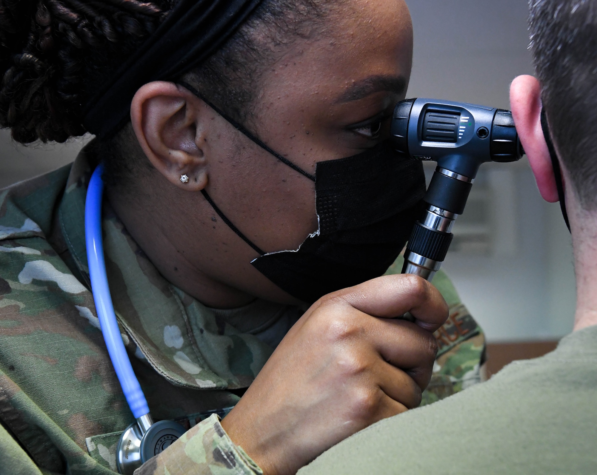 U.S. Air Force Tech. Sgt. Latasha Smith, 86th Operational Medical Readiness Squadron warrior medicine clinic flight chief, performs an ear exam on a patient at Ramstein Air Base, Germany, Feb. 3, 2022. The ear exam is part of a health and wellness check that ensures that an Airman is ready for a deployment.  (U.S. Air Force photo by Airman 1st Class Jared Lovett)