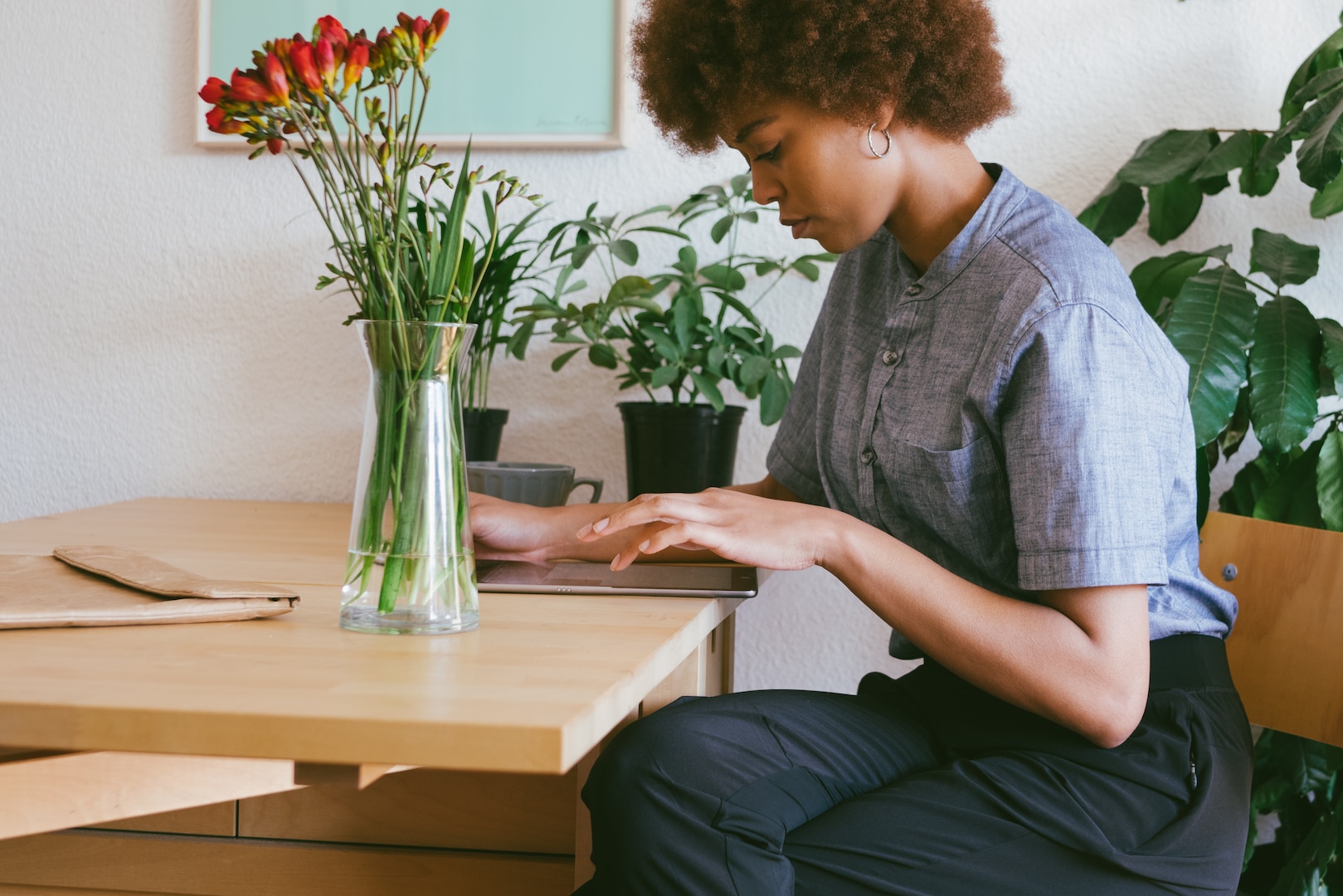 Woman sitting at a desk using a tablet