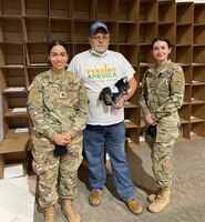 Volunteer Soldiers in uniform stand with volunteer