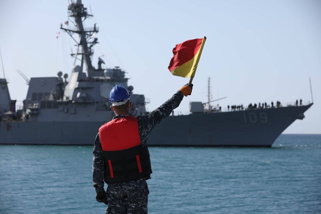 BERENICE, Egypt (Feb. 5, 2022) An Egyptian Navy sailor signals to guided-missile destroyer USS Jason Dunham (DDG 109) in Berenice, Egypt, Feb. 5, during International Maritime Exercise/Cutlass Express 2022. IMX/Cutlass Express 2022 is the largest multinational training event in the Middle East, involving more than 60 nations and international organizations committed to enhancing partnerships and interoperability to strengthen maritime security and stability. (U.S. Army photo by Sgt. David Resnick)