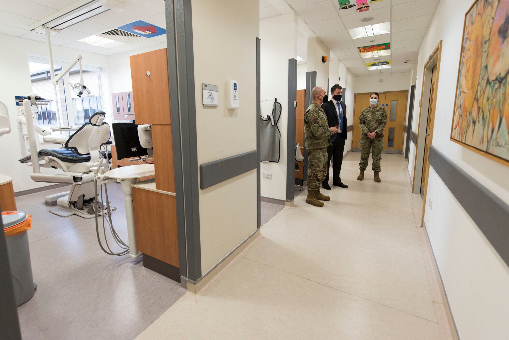 U.S. Air Force Lt. Col. Darrell Lee, left, 423rd Medical Squadron commander, and Master Sgt. Leslie Bush, right, 423rd MDS senior enlisted leader, brief Daryl Brown MBE DL, center, Deputy Lieutenant of Cambridgeshire, and Chief Executive of (Mid-Anglia General Practitioner Accident Service) Magpas Air Ambulance, about the medical squadron at Royal Air Force Alconbury, England. Brown is an incoming Honorary Commander for the 423rd MDS. (U.S. Air Force photo by Senior Airman Jennifer Zima)
