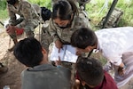 Pfc. Eulalia Andres, center, assigned to 1st Battalion, 37th Armored Regiment, and member of the female engagement team, learns how to speak Pashto and Dari from Afghan evacuees, Sept. 1, 2021, at Fort Bliss' Doña Ana Complex in New Mexico. The Department of Defense, through U.S. Northern Command, and in support of the Department of Homeland Security, is providing transportation, temporary housing, medical screening, and general support for at least 50,000 Afghan evacuees at suitable facilities, in permanent or temporary structures, as quickly as possible. This initiative provides Afghan personnel essential support at secure locations outside Afghanistan. (U.S. Army photo by Sgt. Quintin Gee, 24th Theater Public Affairs Support Element)