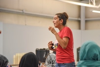 Golnoosh Hakimdavar, who has a doctorate in law and economics, works as a cultural liaison for the Interagency Coordination Center in support of Operation Allies Welcome, translates to guests during the 4th Battalion, 27th Field Artillery Regiment, 2nd Brigade combat team, 1st Armored Division women’s town hall at Fort Bliss’ Doña Ana Complex in New Mexico, Sept. 22, 2021. The Department of Defense, through U.S. Northern Command, and in support of the Department of Homeland Security, is providing transportation, temporary housing, medical screening, and general support for at least 50,000 Afghan evacuees at suitable facilities, in permanent or temporary structures, as quickly as possible. This initiative provides Afghan personnel essential support at secure locations outside Afghanistan. (U.S. Army photo by U.S. Army photo by Sgt. Briaira Tolbert, 1st Armored Division Sustainment Brigade)