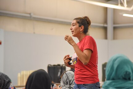 Golnoosh Hakimdavar, who has a doctorate in law and economics, works as a cultural liaison for the Interagency Coordination Center in support of Operation Allies Welcome, translates to guests during the 4th Battalion, 27th Field Artillery Regiment, 2nd Brigade combat team, 1st Armored Division women’s town hall at Fort Bliss’ Doña Ana Complex in New Mexico, Sept. 22, 2021. The Department of Defense, through U.S. Northern Command, and in support of the Department of Homeland Security, is providing transportation, temporary housing, medical screening, and general support for at least 50,000 Afghan evacuees at suitable facilities, in permanent or temporary structures, as quickly as possible. This initiative provides Afghan personnel essential support at secure locations outside Afghanistan. (U.S. Army photo by U.S. Army photo by Sgt. Briaira Tolbert, 1st Armored Division Sustainment Brigade)