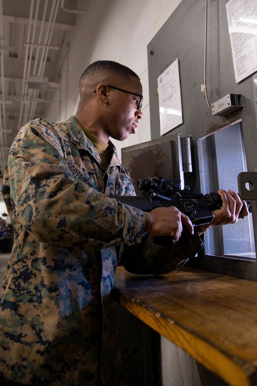 U.S. Marine Corps Lance Cpl. Scott-George receives a rifle through a window at The Basic School, Marine Corps Base Quantico, Virginia, February 2, 2021. “Black History month is a month where we can learn about the history African Americans have in this country, and it gives us a chance to learn about and celebrate important people in black history and what they have accomplished,” Scott-George said. Throughout Black History Month, the Marine Corps joins the nation in celebrating representation, the identity of every individual Marine and the diversity that strengthens the Corps. (U.S Marine Corps photo by Lance Cpl. Payton Goodrich)