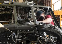 Installing electronics into a Blackhawk helicopter.