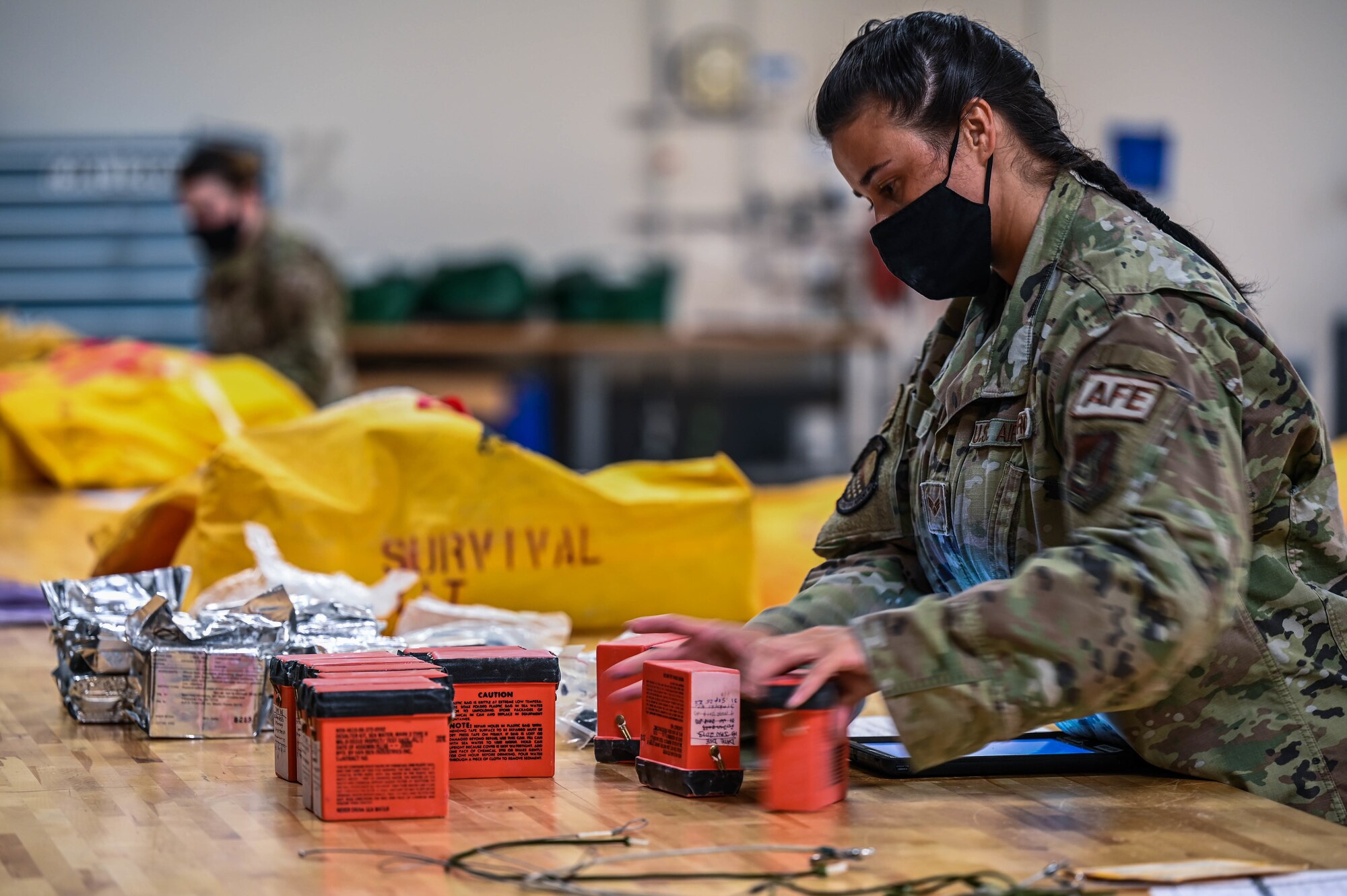 Senior Airman Leyna Clarice, 15th Operations Support Squadron aircrew flight equipment journeyman inspects survival kits during a functional check at Joint Base Pearl Harbor-Hickam, Hawaii, Feb. 1, 2022. AFE Airmen inspect, maintain and service all safety gear for the C-17 Globemaster III ensuring the aircrew’s safety. (U.S. Air Force photo by Staff Sgt. Alan Ricker)