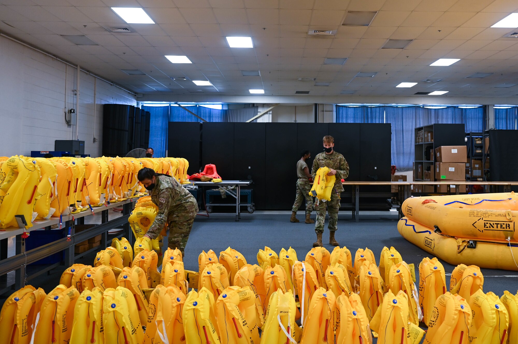 Airmen from the 15th Operations Support Squadron aircrew flight equipment perform survival equipment functional checks at Joint Base Pearl Harbor-Hickam, Hawaii, Feb. 1, 2022. AFE Airmen inspect, maintain and service all safety gear for the C-17 Globemaster III ensuring the aircrew’s safety. (U.S. Air Force photo by Staff Sgt. Alan Ricker)