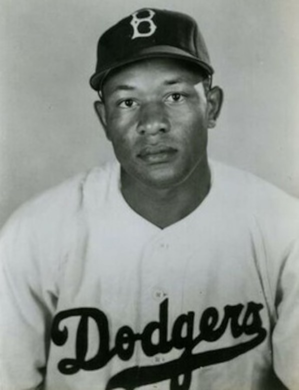A baseball player poses for photo.