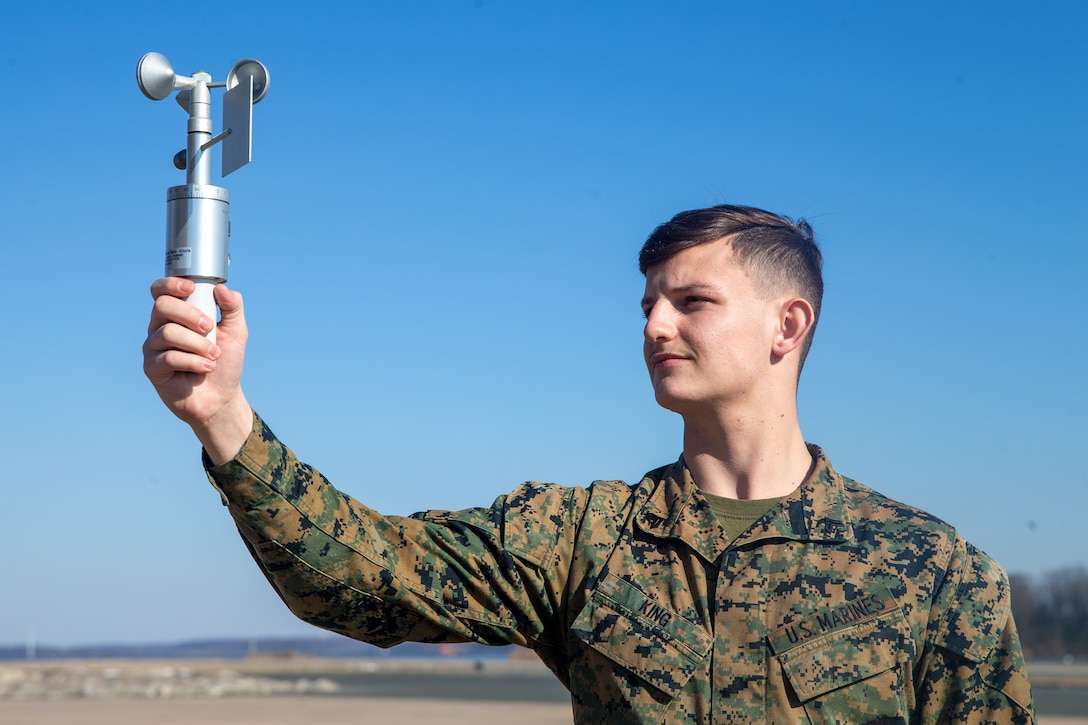 U.S. Marine Corps Cpl. Haydon R. King, a meteorology and oceanography (METOC) analyst forecaster with Marine Corps Air Facilities Quantico, reads the information off of an anemometer at Marine Corps Base Quantico, Virginia, Jan. 26, 2022. The anemometer is a weather instrument used to read both wind speed and direction. (US Marine Corps photo by Lance Cpl. Kayla LaMar)