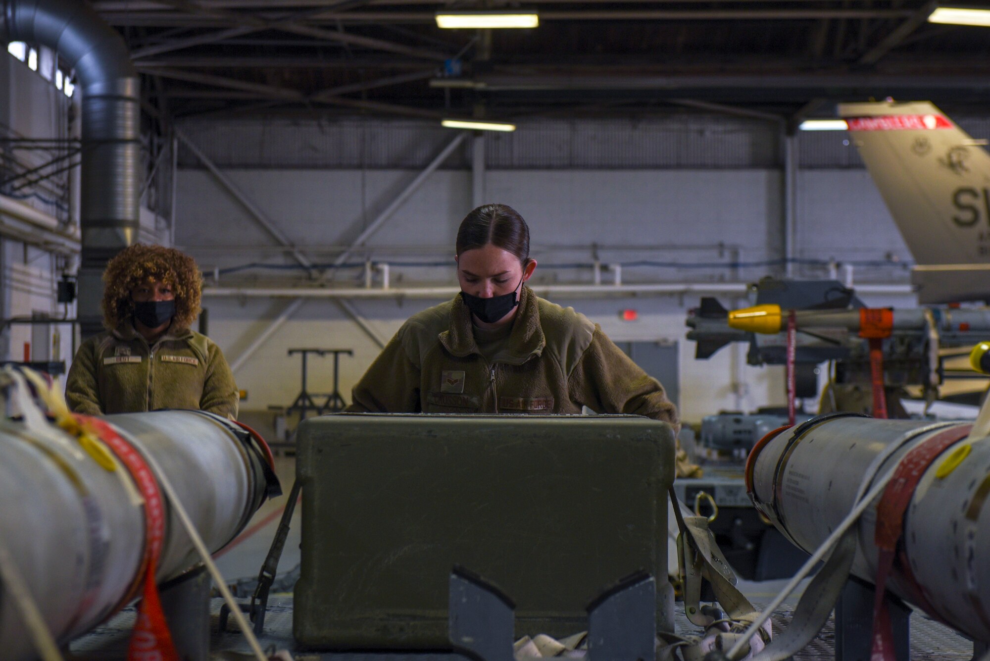 An Airman loads practice munitions.