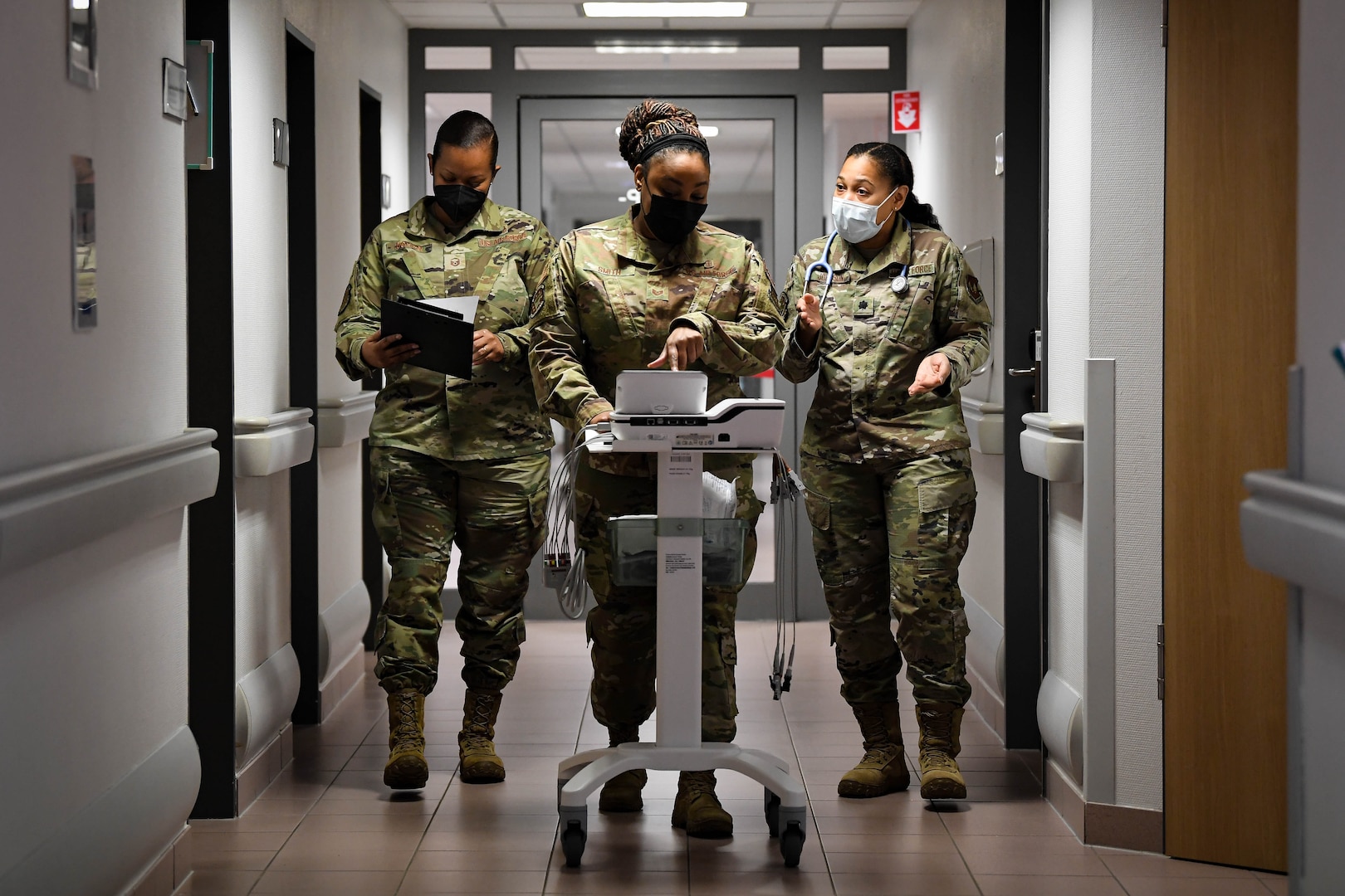 Airmen assigned to the 86th Medical Group discuss training for medics regarding the new ElectroCardiogram (EKG) at Ramstein Air Base, Germany, Feb. 3, 2022. An EKG takes a snapshot of a patient's cardiac rhythms, which helps medical providers diagnose and treat dysrhythmia. (U.S. Air Force photo by Airman 1st Class Jared Lovett)