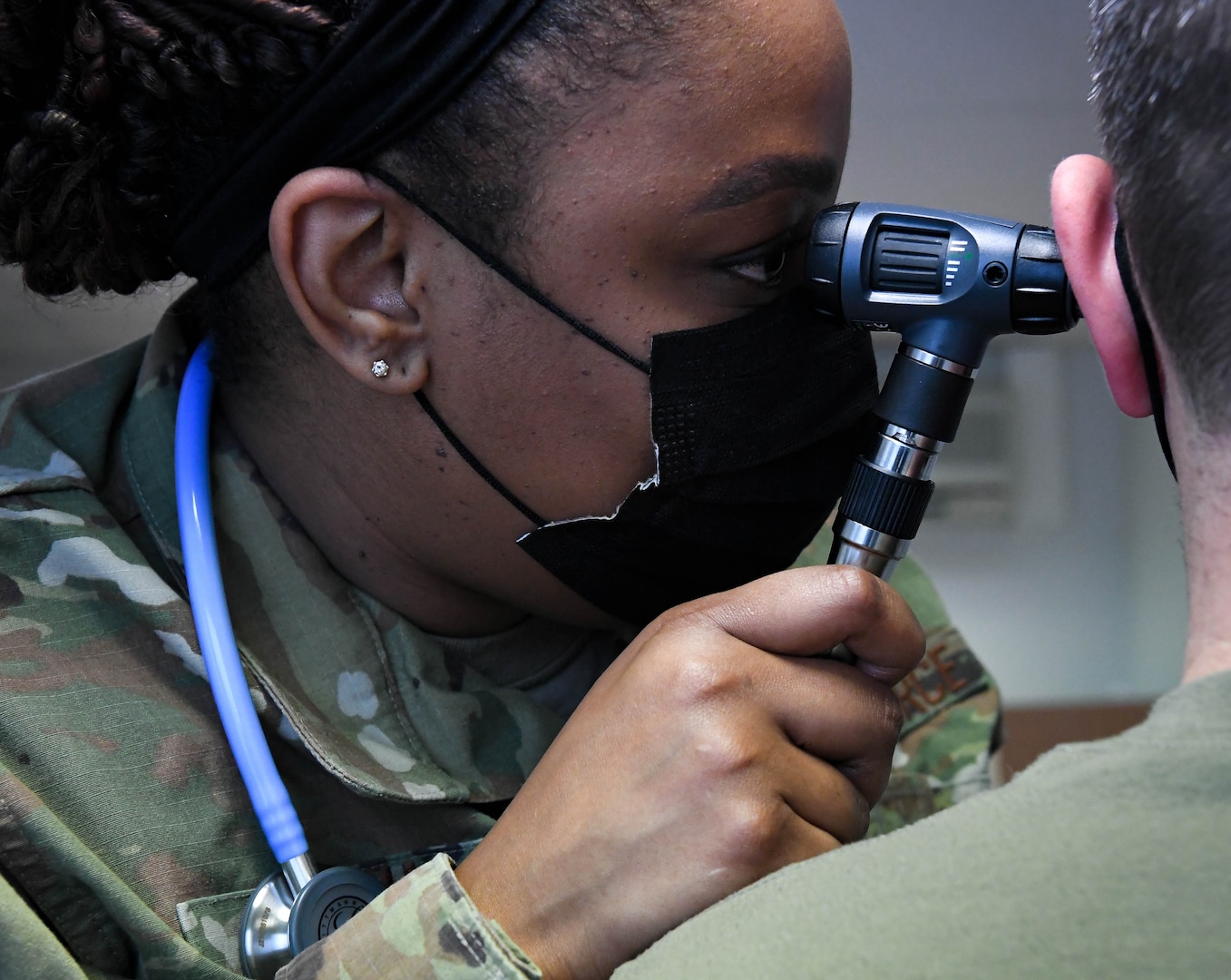 U.S. Air Force Tech. Sgt. Latasha Smith, 86th Operational Medical Readiness Squadron warrior medicine clinic flight chief, performs an ear exam on a patient at Ramstein Air Base, Germany, Feb. 3, 2022. The ear exam is part of a health and wellness check that ensures that an Airman is ready for a deployment.  (U.S. Air Force photo by Airman 1st Class Jared Lovett)