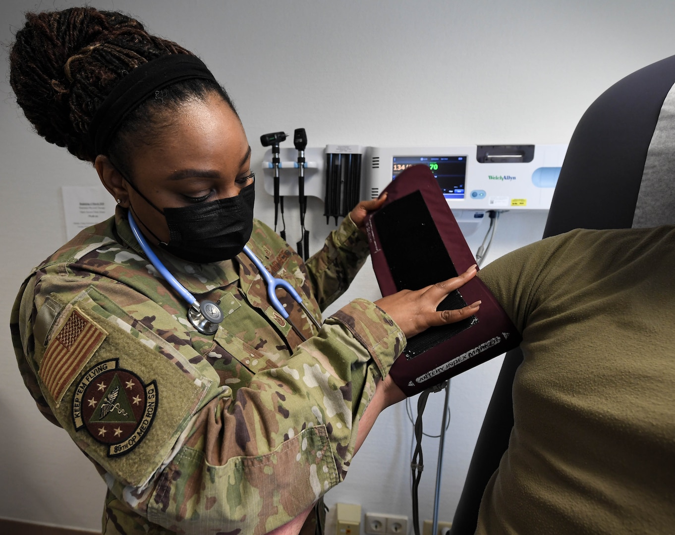 U.S. Air Force Tech. Sgt. Latasha Smith, 86th Operational Medical Readiness Squadron warrior medicine clinic flight chief, checks a patient’s vital signs at Ramstein Air Base, Germany, Feb. 3, 2022. Checking a patient’s vital signs is part of a health and wellness check that ensures that an Airman is ready for a  deployment. (U.S. Air Force photo by Airman 1st Class Jared Lovett)