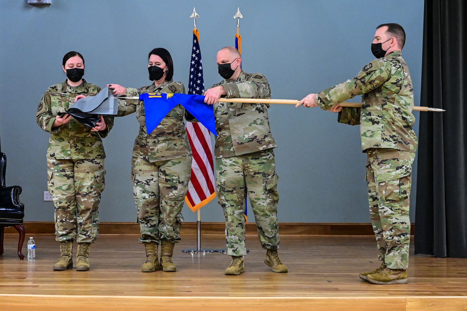 Col. Jennifer Bratz, 19th Medical Group commander, and Lt. Col. Randolph Bosch, former 19th Medical Support Squadron commander, right, case the furled 19th MDSS flag