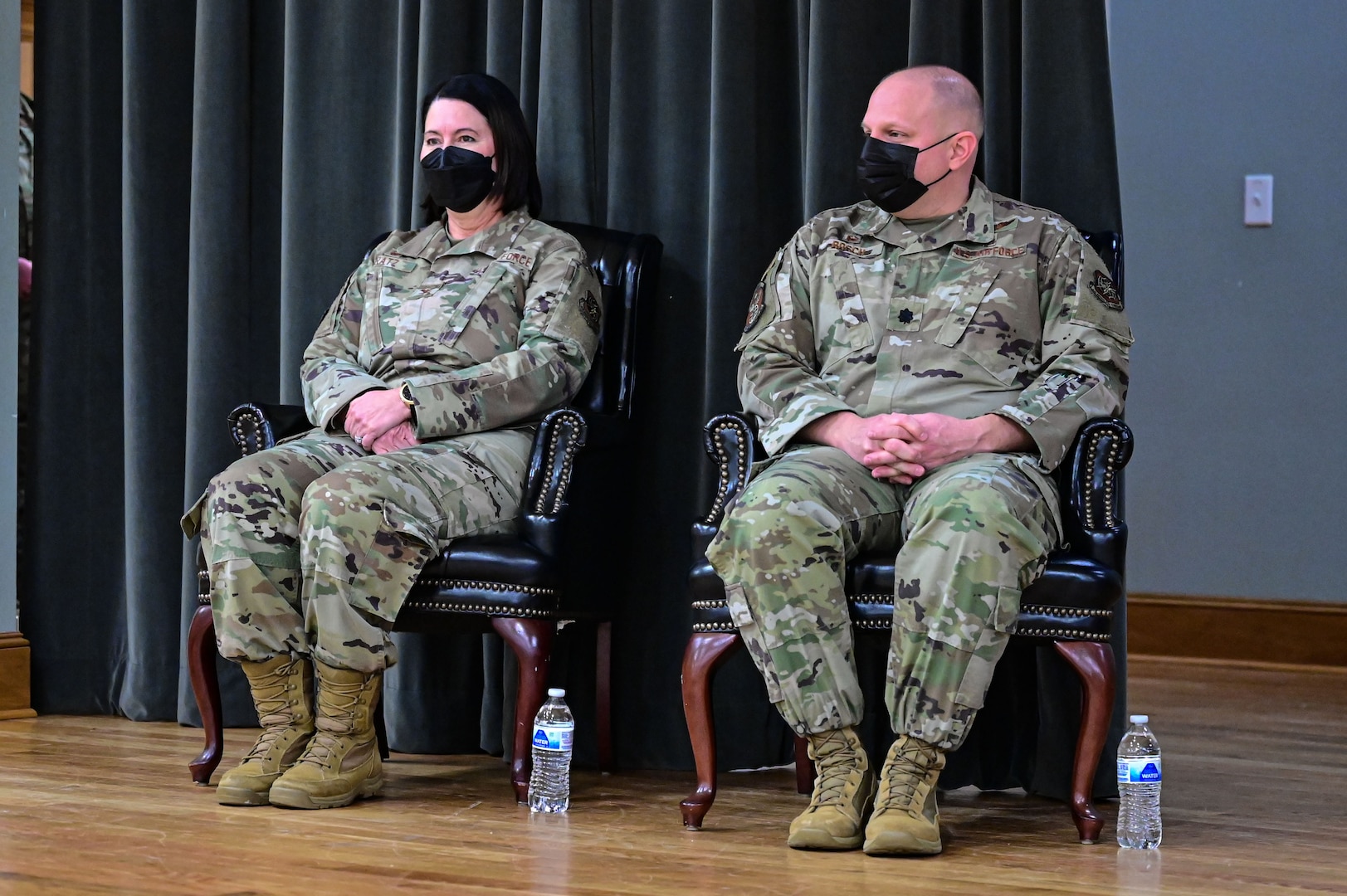 Col. Jennifer Bratz, 19th Medical Group commander, left, and Lt. Col. Randolph Bosch, former 19th Medical Support Squadron commander, right, attend the 19th MDSS inactivation ceremony