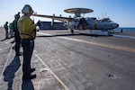 An aircraft launches from an aircraft carrier.