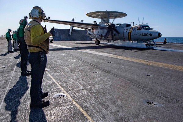 An aircraft launches from an aircraft carrier.