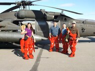 Alaska Army National Guard Environmental Section team members, wearing emergency flotation suits for flying over bodies of water, prepare to review a site for divestiture in Nome, Alaska, June 18, 2014. (Courtesy photo)