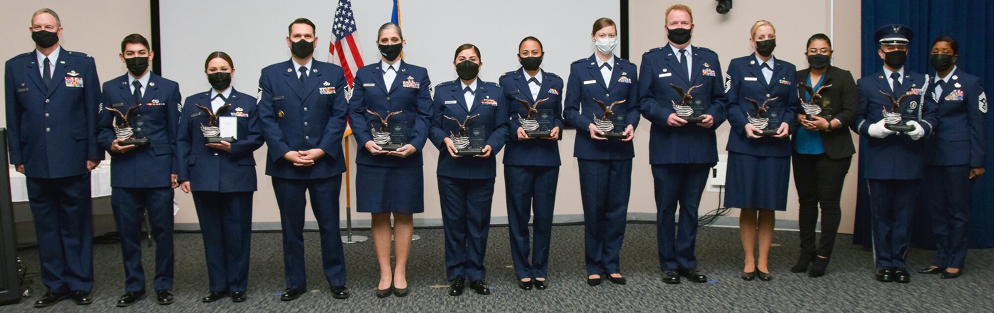 Col. Terry McClain, 433rd Airlift Wing commander, and Chief Master Sgt. Takesha Williams, 433rd AW command chief, stand with the annual wing award winners after the awards ceremony Feb. 5, 2022, at Joint Base San Antonio-Lackland, Texas. (U.S. Air Force photo by Staff Sgt. Monet Villacorte)