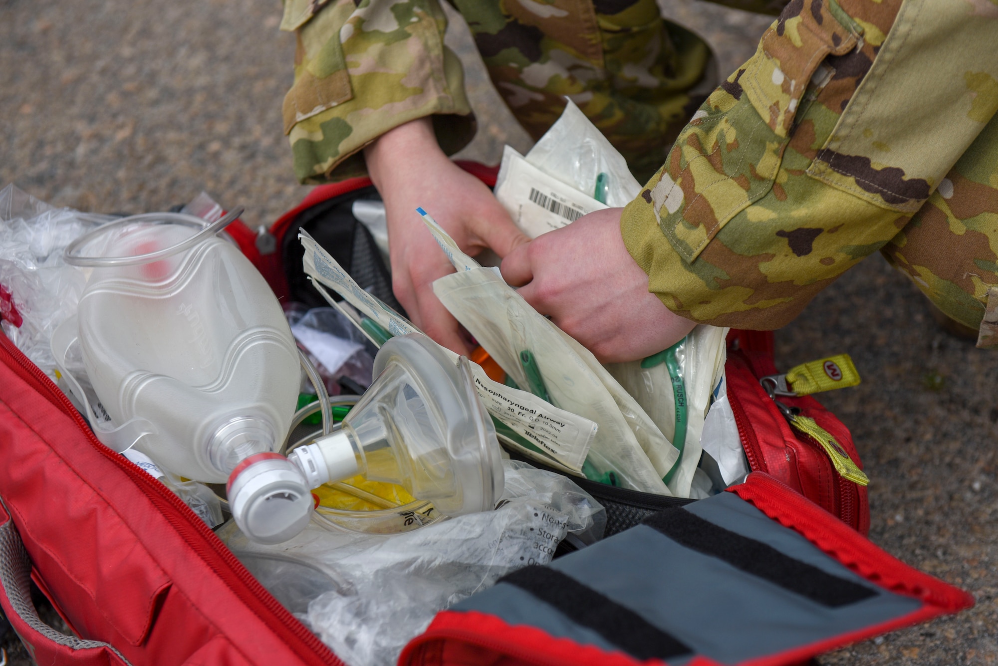An airman displays a safety kit.