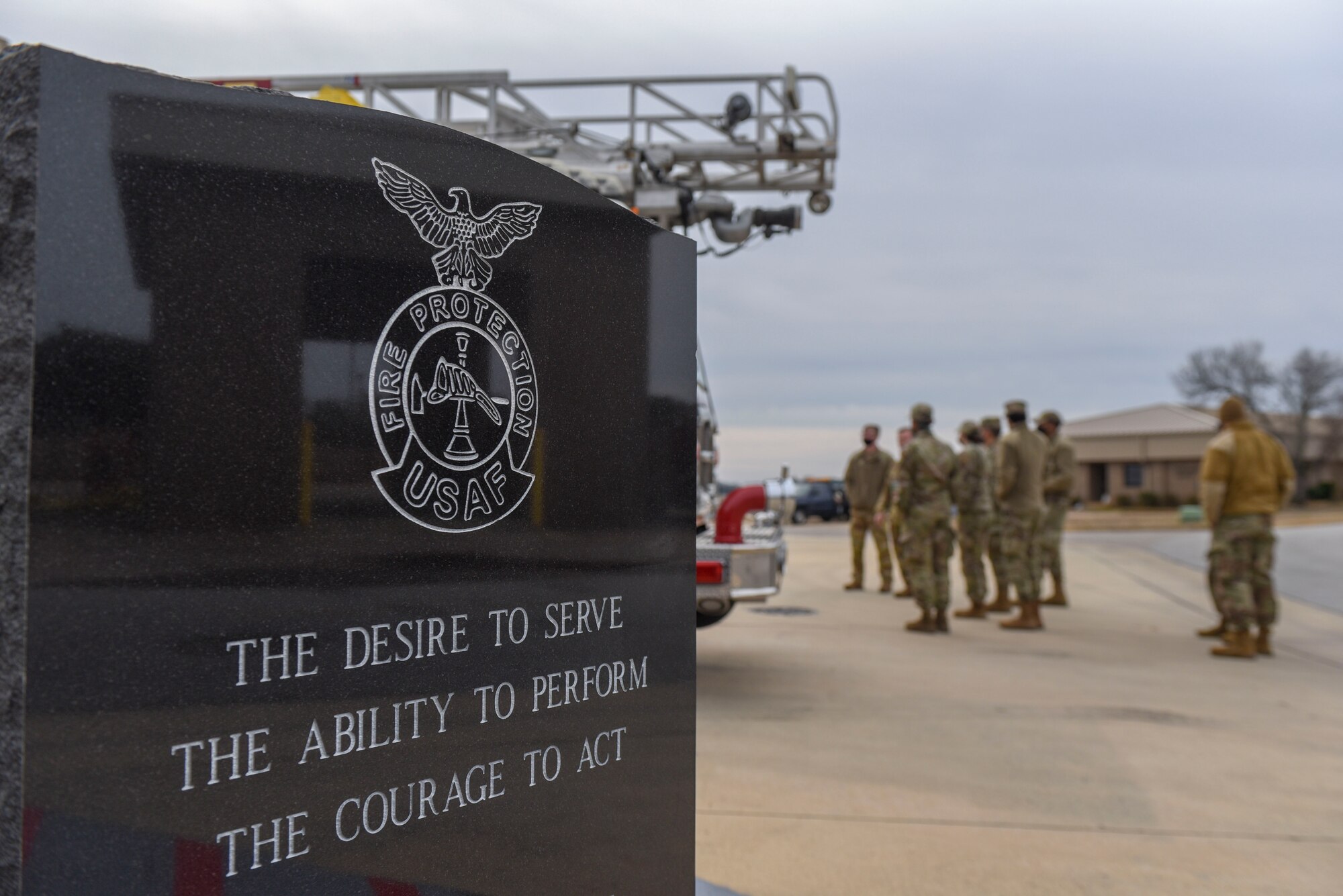 A group of Airmen listen to a tour guide.