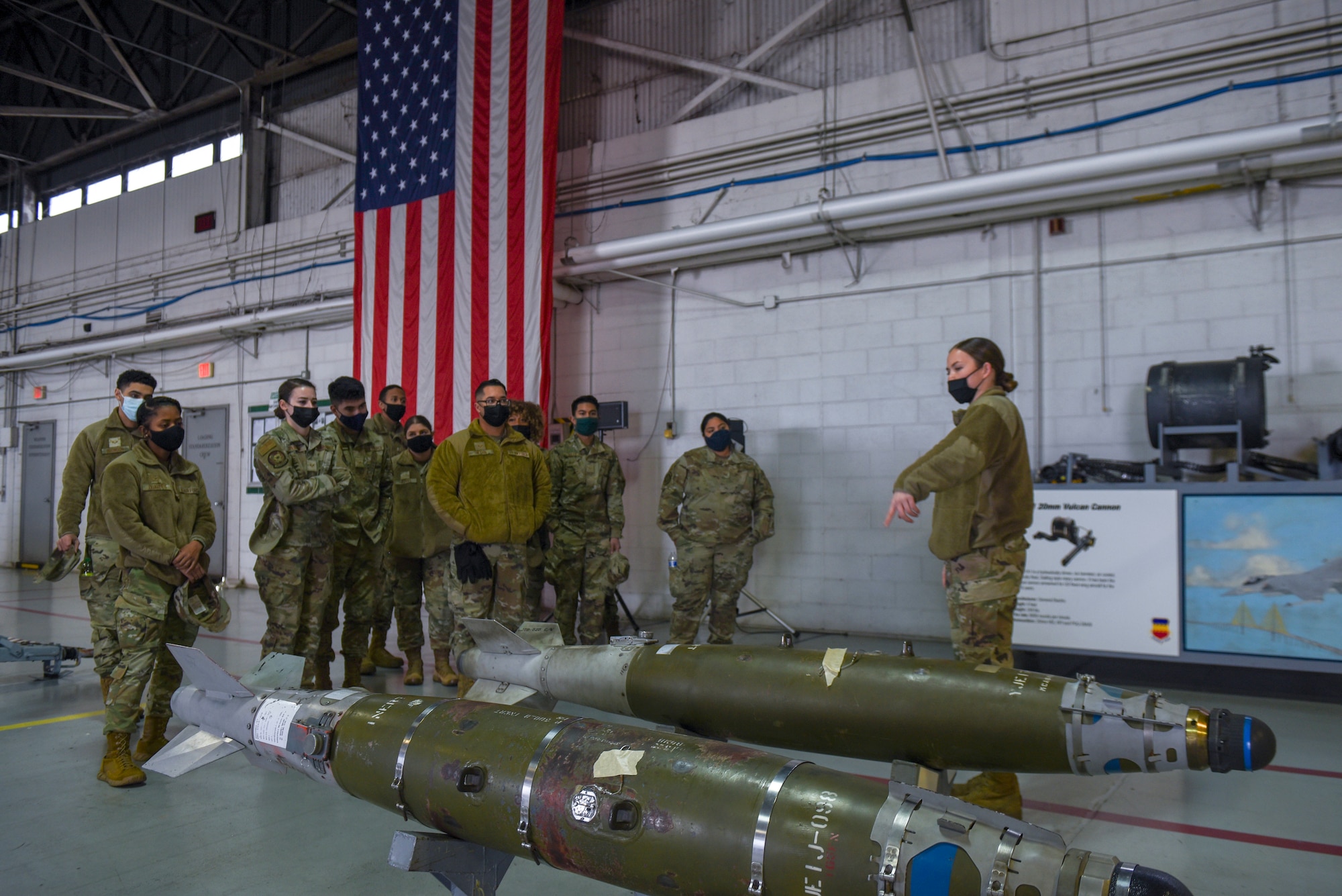 A group of Airmen take part in a tour of the 20th Maintenance Group.