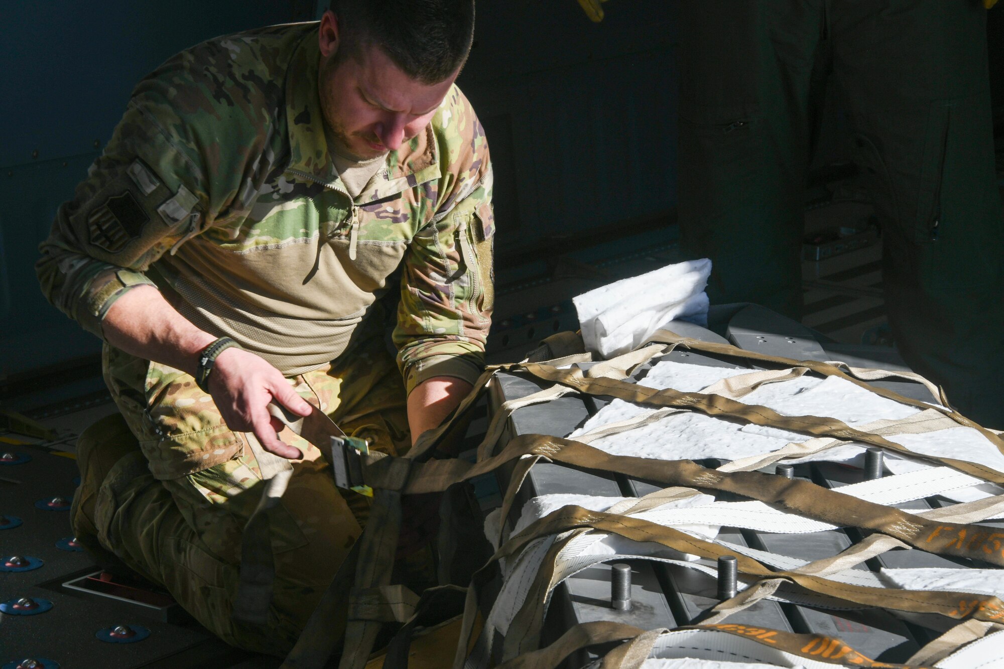 U.S. Air Force Tech. Sgt. Jacob Nenneman, 56th Air Refueling Squadron (ARS) loadmaster, straps down cargo on a KC-46 Pegasus on Luke Air Force Base, Arizona, Jan. 27, 2022. Silver Paladin gave loadmasters from the 56th ARS the opportunity to conduct real-world loading operations outside of training simulations. . (U.S. Air Force photo by Airman 1st Class Trenton Jancze)