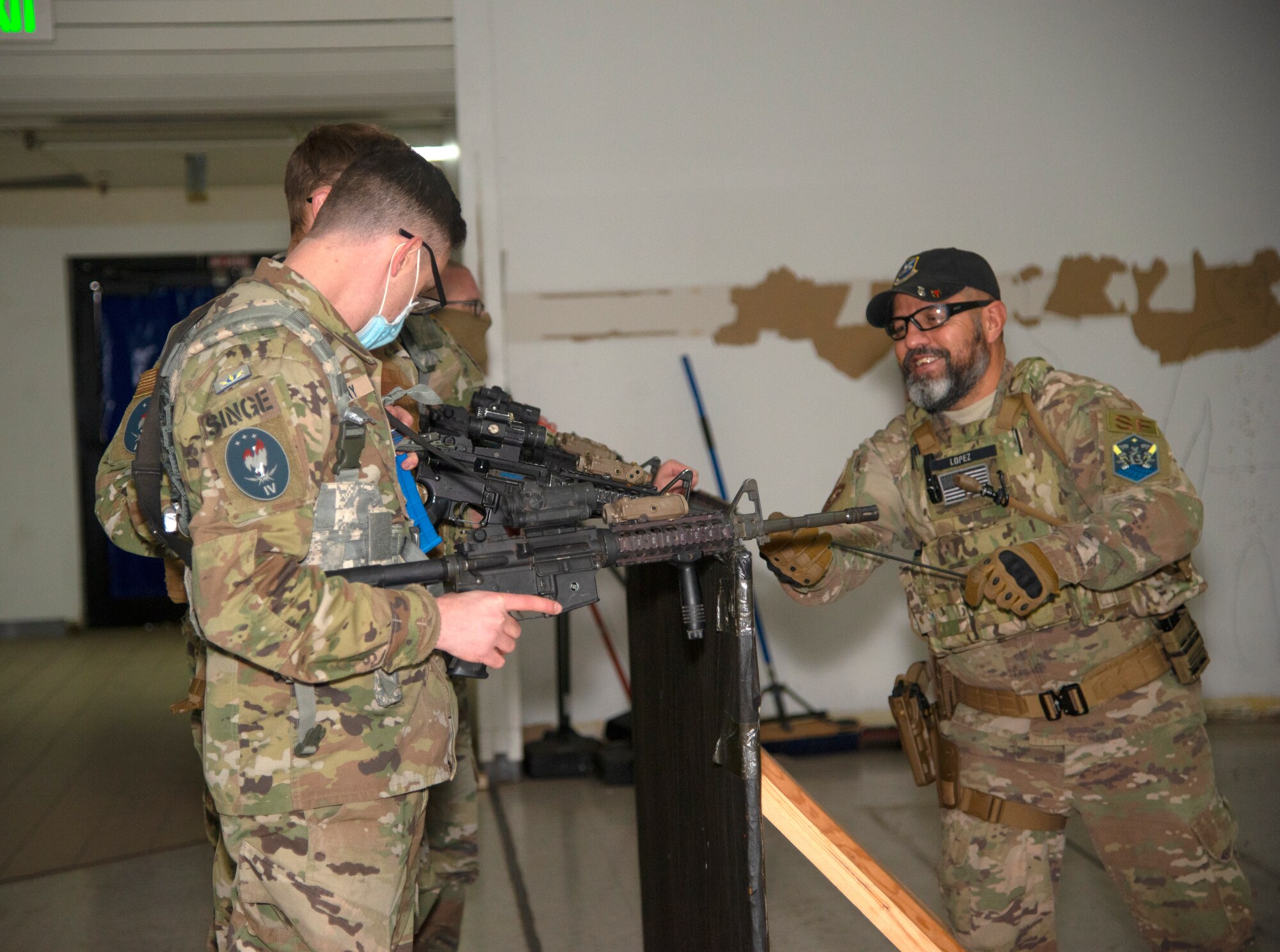 Isaac Lopez, 21st Security Forces Squadron unit trainer provides instruction to U.S. Space Force Tech. Sgt. Jeffrey “Singe” Matheny, Space Delta 3 Space Electromagnetic Warfare, 4th Space Control Squadron noncommissioned officer in charge of weapons and tactics during combatives and small arm tactics training on Peterson Space Force Base Jan. 12, 2022.