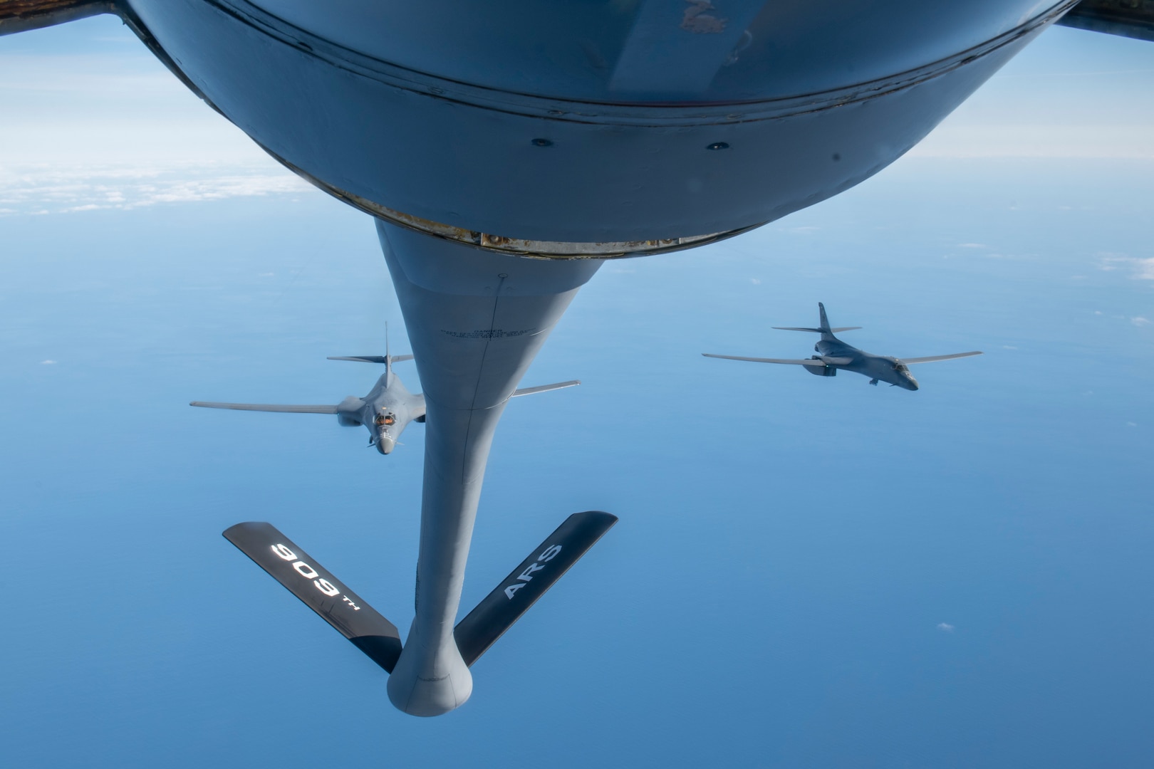 Two B-1 Lancers from the 7th Bomb Wing fly behind A KC-135R Stratotanker after receiving fuel over the Pacific Ocean during a Bomber Task Force deployment, Jan. 11, 2022. A BTF deployment of U.S. Air Force B-1 Lancers, Airmen and support equipment from the 7th Bomb Wing, Dyess Air Force Base, Texas, coordinated with the 909th Air Refueling Squadron to support Pacific Air Forces’ training efforts with allies, partners, and joint forces and strategic deterrence missions to reinforce the rules-based international order in the Indo-Pacific region. (U.S. Air Force photo by Airman 1st Class Moses Taylor)