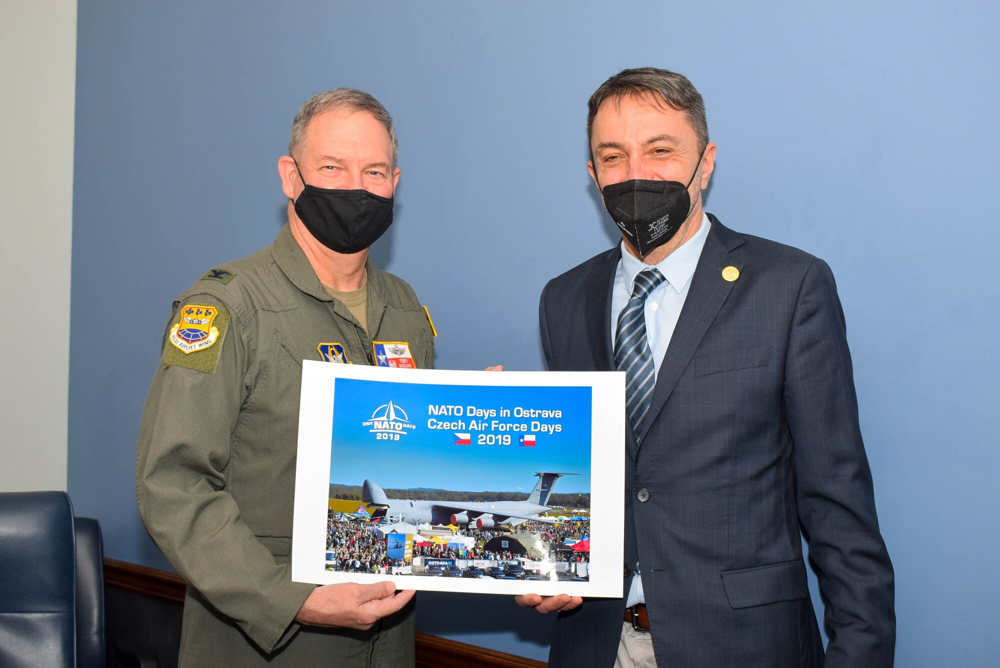Col. Terry McClain, 433rd Airlift Wing commander, and Zbyněk Pavlačík, CEO and co-founder of Jagello 2000 Association, hold a photograph Jan. 25, 2022, of the wing’s C-5M Super Galaxy aircraft being showcased in 2019 in the Czech Republic, at Joint Base San Antonio-Lackland, Texas. (U.S. Air Force photo by Airman Mark Colmenares)